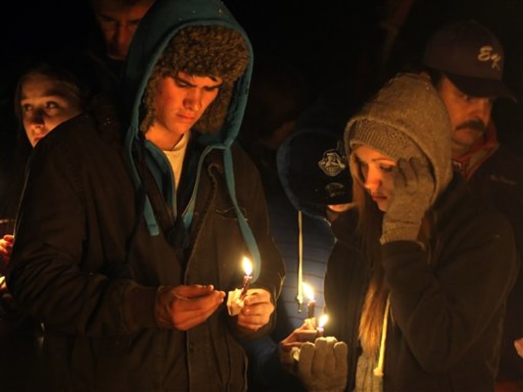 Local residents gather to sing and pray during a vigil for the three missing people who were found dead Thursday, Nov. 18, 2010, in Howard, Ohio. (AP Photo/Jay LaPrete)